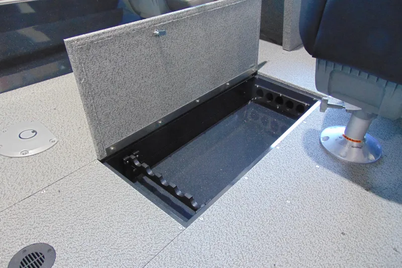 Slide: The Image of 2026 Crestliner 1650 Kodiak boat interior with open storage compartment and seating. - 12