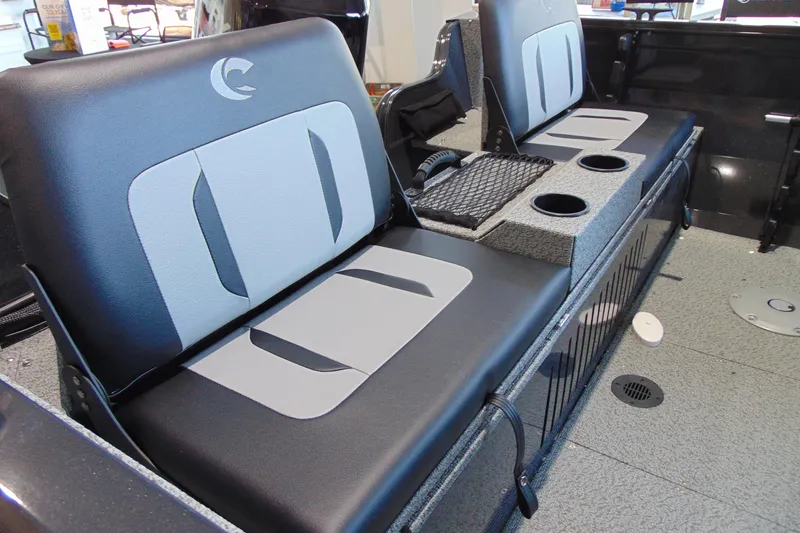 Slide: The Image of 2026 Crestliner 1650 Kodiak boat interior with cushioned seating and cup holders. - 14