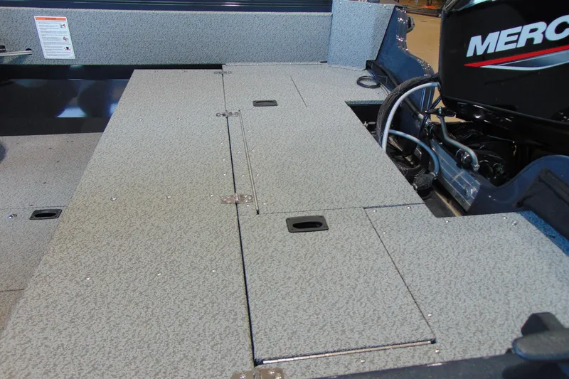 Slide: The Image of 2026 Crestliner 1650 Kodiak boat deck with Mercury engine, showcasing storage compartments. - 15