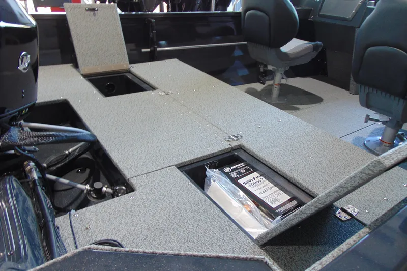 Slide: The Image of 2026 Crestliner 1650 Kodiak boat interior with storage compartments and seating. - 16