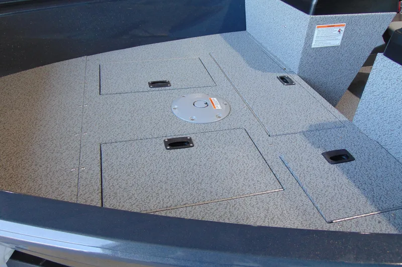 Slide: The Image of 2026 Crestliner 1650 Kodiak boat deck with storage compartments and textured surface. - 17