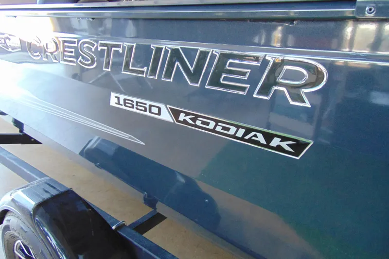 Slide: The Image of 2026 Crestliner 1650 Kodiak boat side view with logo and model details. - 3