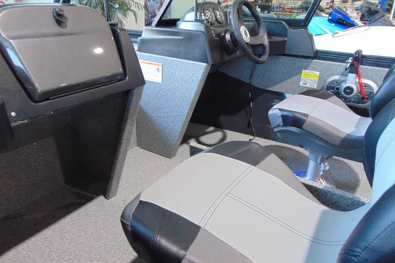 Slide: The Image of Interior of 2026 Crestliner 1650 Kodiak boat with modern seating and dashboard. - 7