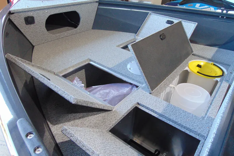 Slide: The Image of 2026 Crestliner 1650 Kodiak boat interior with open storage compartments. - 8