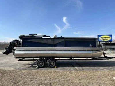 The Image of 2025 Lowe LS 230 WT pontoon boat on trailer under clear blue sky. - 0