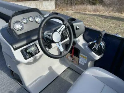 Slide: The Image of 2025 Lowe LS 230 WT boat dashboard with steering wheel and control panel. - 7