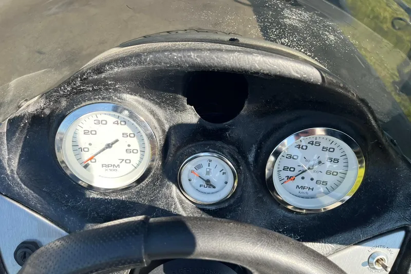 Slide: The Image of 2008 Tracker Pro Team 175 TXW dashboard with RPM, fuel, and speed gauges. - 13
