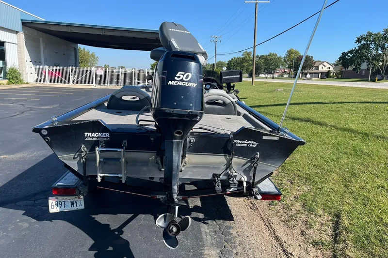 Slide: The Image of 2008 Tracker Pro Team 175 TXW boat with Mercury 50 engine, parked outdoors. - 2
