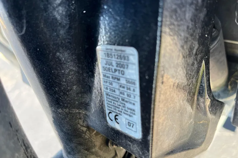 Slide: The Image of Close-up of a 2008 Tracker Pro Team 175 TXW engine label with specifications. - 23