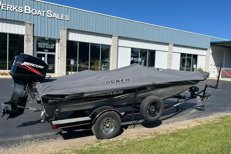 Slide: The Image of 2008 Tracker Pro Team 175 TXW boat with cover, parked outside a boat sales shop. - 5