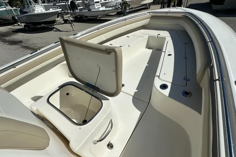 Slide: The Image of Open storage compartment on 2012 Blackwood 270 boat deck, surrounded by other boats. - 10