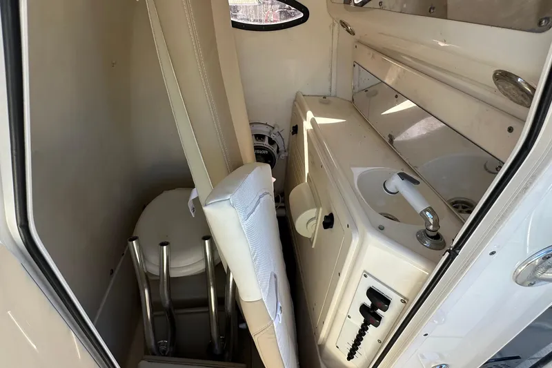 Slide: The Image of Interior of a 2012 Blackwood 270 boat featuring a compact sink and seating area. - 12