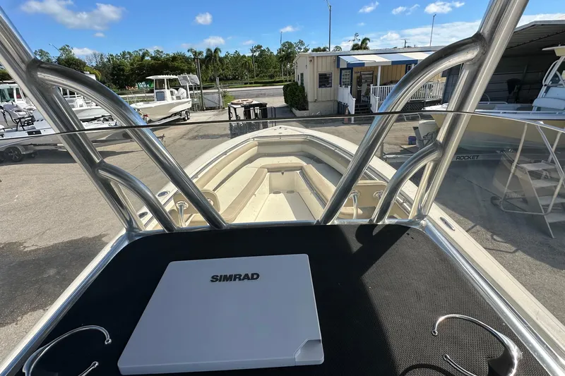 Slide: The Image of 2012 Blackwood 270 boat with Simrad navigation, docked at a marina under clear skies. - 14