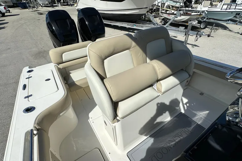 Slide: The Image of 2012 Blackwood 270 boat interior with beige seating and dual outboard motors. - 15
