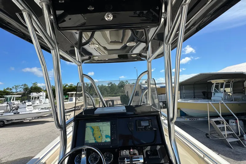Slide: The Image of 2012 Blackwood 270 boat dashboard with navigation system, docked under clear blue sky. - 5