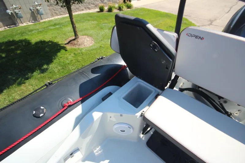 Slide: The Image of 2018 Zodiac Open 7 NEO boat interior with open storage compartment and seating. - 11