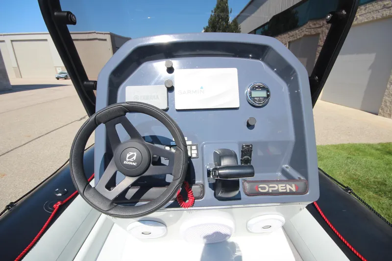 Slide: The Image of 2018 Zodiac Open 7 NEO boat dashboard with steering wheel and controls. - 14