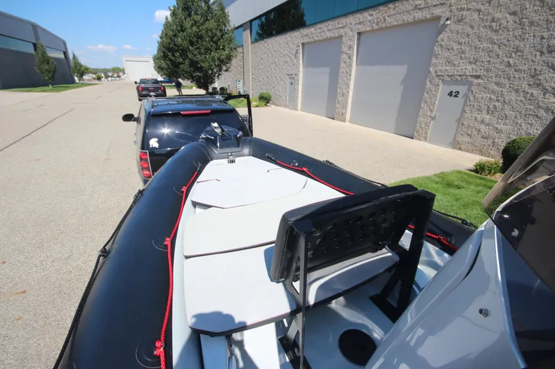 Slide: The Image of 2018 Zodiac Open 7 NEO boat on trailer, parked near industrial building. - 15