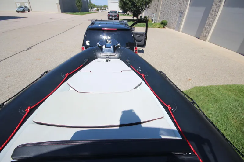 Slide: The Image of 2018 Zodiac Open 7 NEO boat on trailer, viewed from above, parked near buildings. - 16