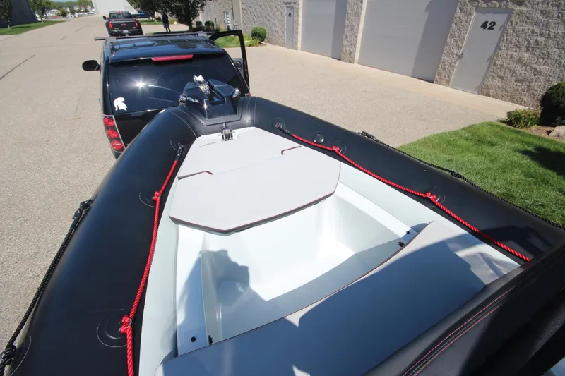 Slide: The Image of 2018 Zodiac Open 7 NEO boat on trailer, parked on street. - 17