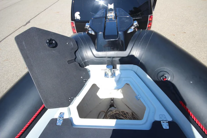 Slide: The Image of 2018 Zodiac Open 7 NEO boat with open storage compartment and trailer. - 21