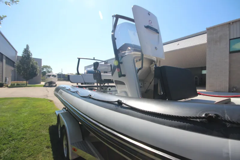 Slide: The Image of 2018 Zodiac Open 7 NEO boat on trailer, parked outdoors near buildings. - 22