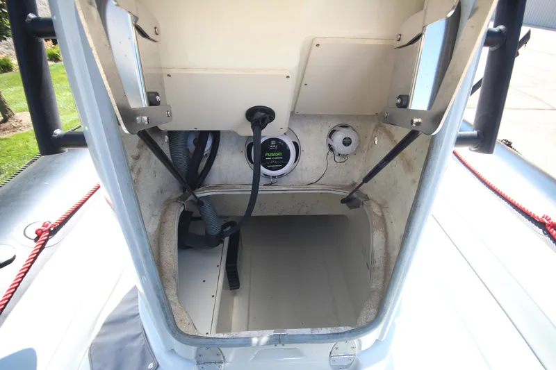 Slide: The Image of 2018 Zodiac Open 7 NEO boat interior with storage compartment and audio system. - 23