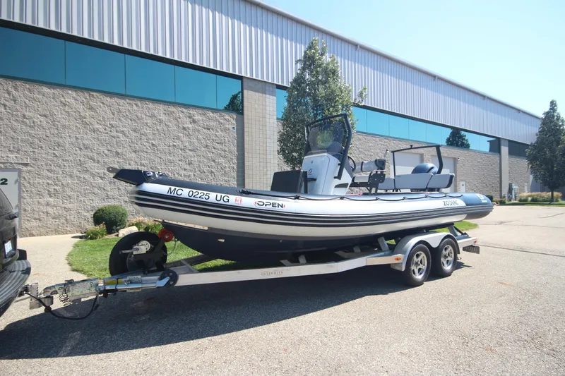 Slide: The Image of 2018 Zodiac Open 7 NEO boat on trailer, parked outside industrial building. - 27