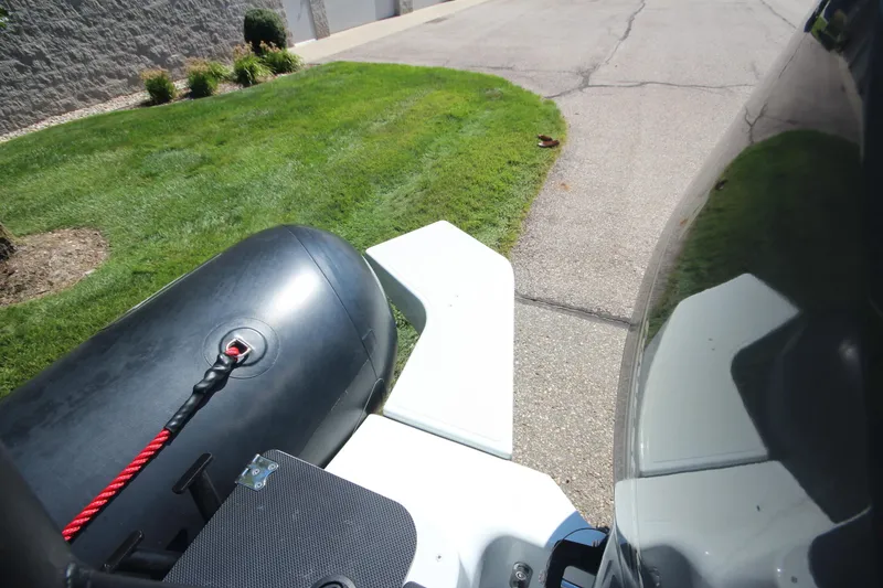 Slide: The Image of 2018 Zodiac Open 7 NEO boat on trailer, parked on a residential street. - 7