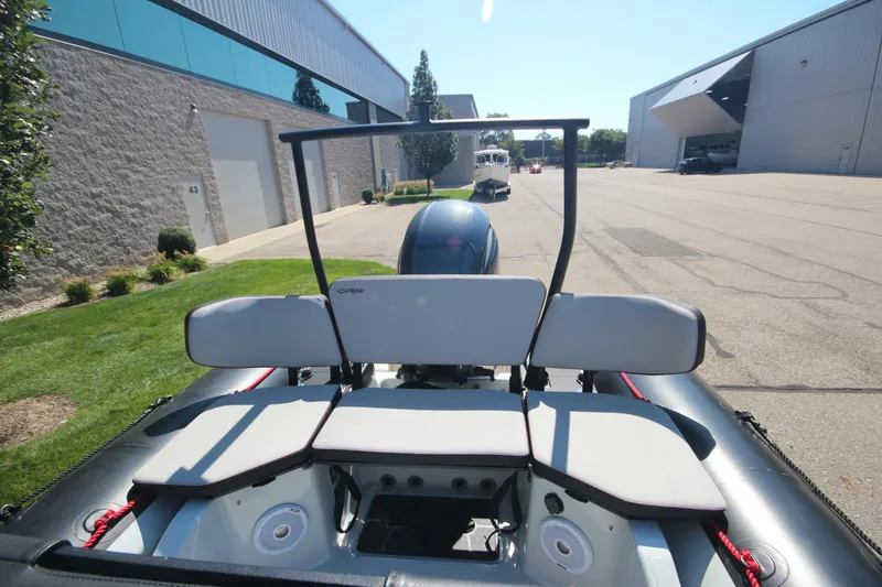 Slide: The Image of 2018 Zodiac Open 7 NEO boat with trailer, parked outside industrial building. - 8