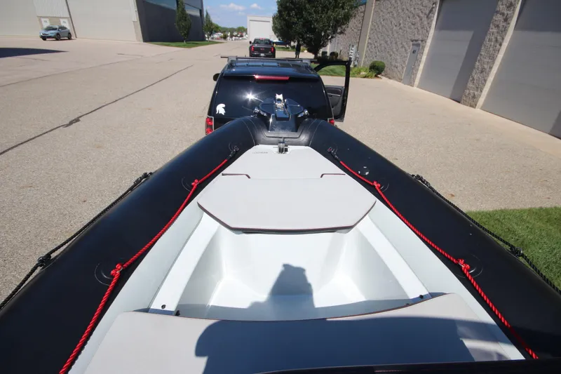 Slide: The Image of 2018 Zodiac Open 7 NEO boat on trailer, parked in industrial area. - 18