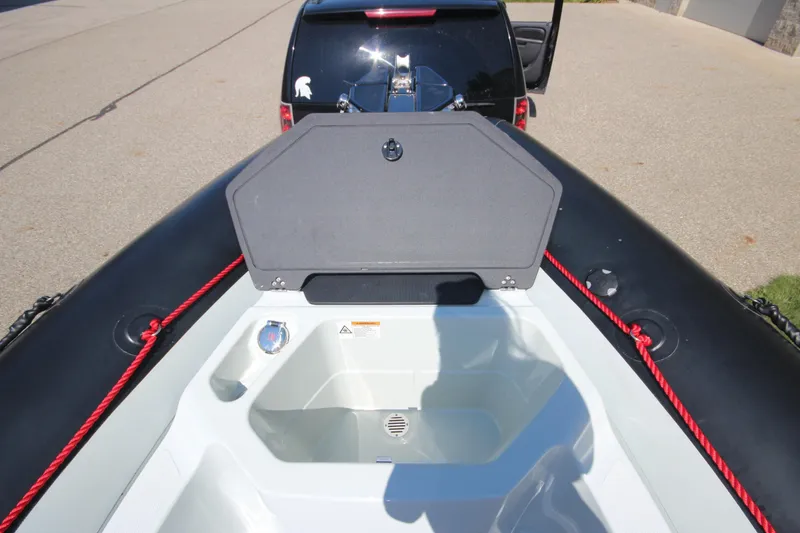Slide: The Image of 2018 Zodiac Open 7 NEO boat with trailer, featuring open storage compartment. - 20
