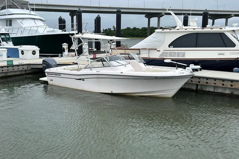The Image of 2011 Grady-White Freedom 225 boat docked in marina, with bridge in background. - 0