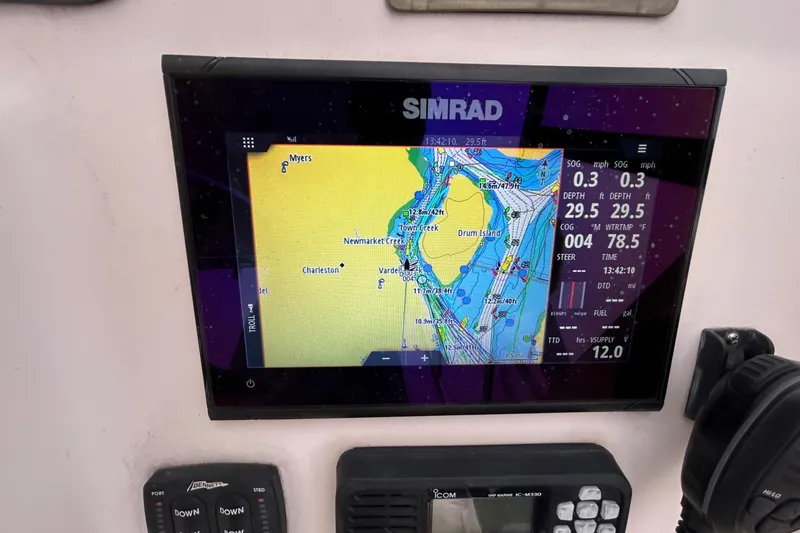 Slide: The Image of Simrad navigation display on 2011 Grady-White Freedom 225 boat, showing nautical chart and data. - 11