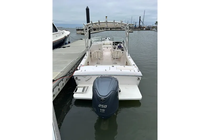 Slide: The Image of 2011 Grady-White Freedom 225 boat docked, featuring a powerful 250 V6 engine. - 2