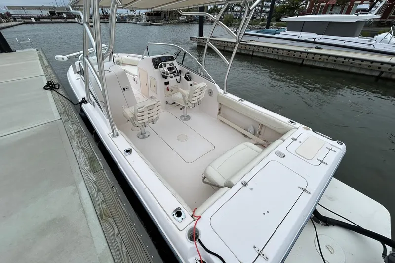 Slide: The Image of 2011 Grady-White Freedom 225 boat docked at marina, featuring spacious seating and helm. - 3