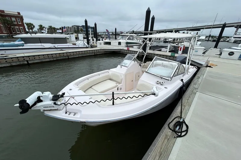 Slide: The Image of 2011 Grady-White Freedom 225 boat docked at marina, overcast sky. - 4
