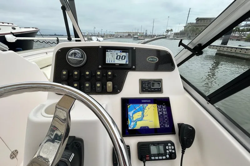 Slide: The Image of 2011 Grady-White Freedom 225 boat dashboard with navigation and control systems. - 7