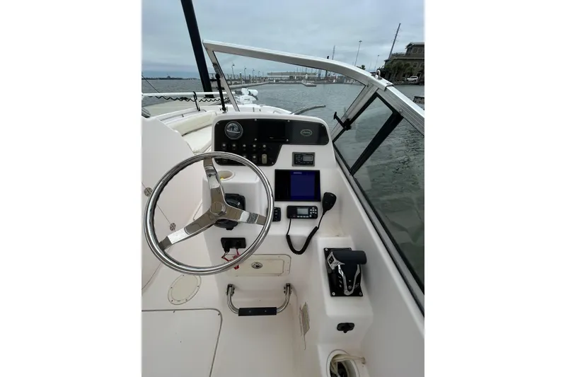Slide: The Image of 2011 Grady-White Freedom 225 boat helm with steering wheel and control panel. - 8