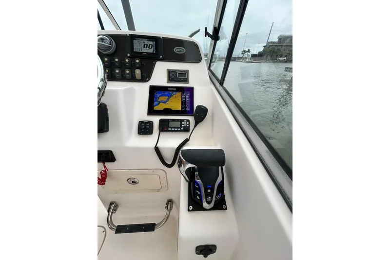 Slide: The Image of 2011 Grady-White Freedom 225 boat dashboard with navigation equipment and controls. - 9