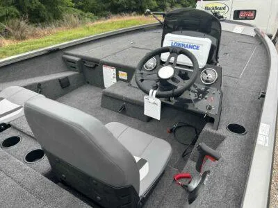 Slide: The Image of 2025 Lowe Stinger 195 Crappie boat interior with steering console and seating. - 7