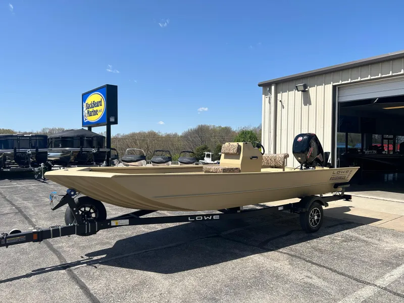 Slide: The Image of 2025 Lowe Roughneck 2070 CC boat on trailer outside dealership under clear blue sky. - 3