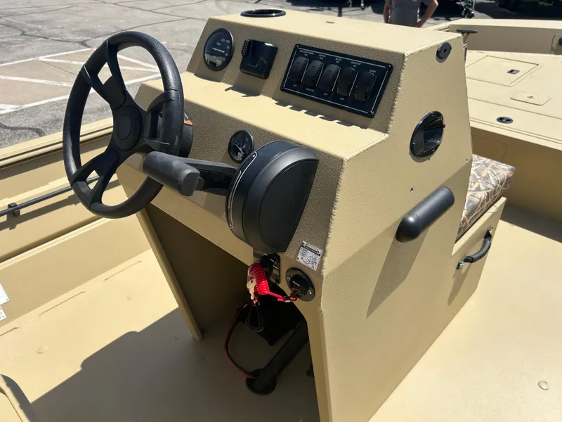 Slide: The Image of 2025 Lowe Roughneck 2070 CC boat console with steering wheel and control panel. - 7