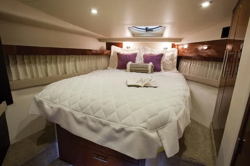 Slide: The Image of Luxurious bedroom in 2014 Regal 42 Sport Coupe yacht with cozy bedding and ambient lighting. - 25