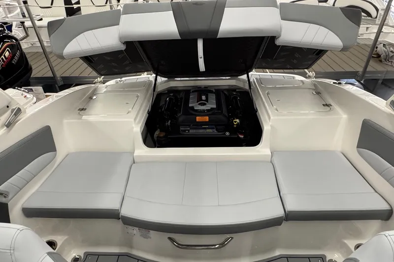Slide: The Image of 2026 Chaparral 21 SSi boat interior with open engine compartment and cushioned seating. - 20
