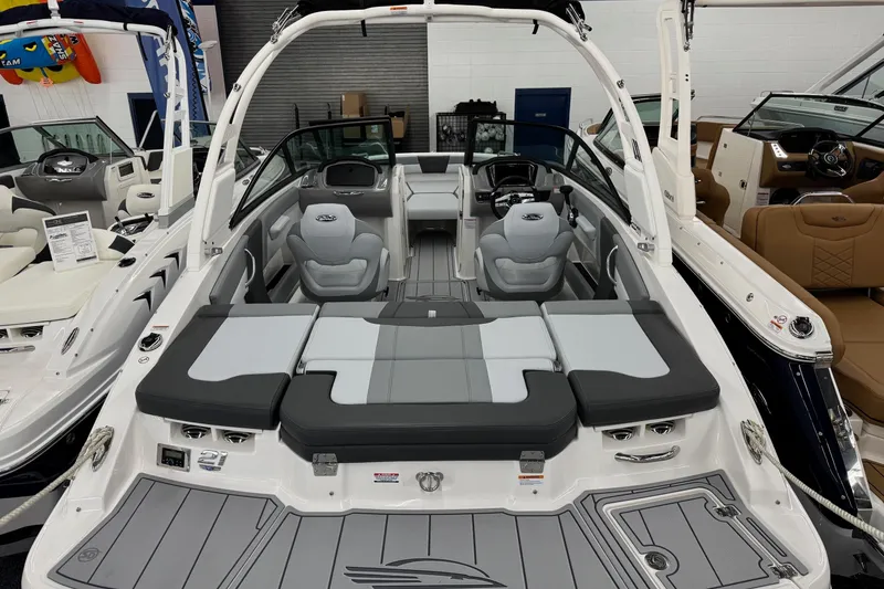 Slide: The Image of 2026 Chaparral 21 SSi boat interior with gray seating and modern dashboard. - 22