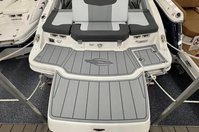 Slide: The Image of 2026 Chaparral 21 SSi boat with sleek gray deck and seating area. - 25