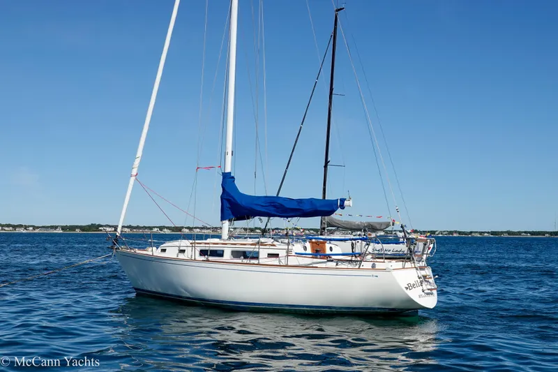 Slide: The Image of 1984 Sabre 32 Aft-Cabin sailboat on calm blue waters under clear sky. - 3