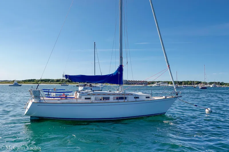 Slide: The Image of 1984 Sabre 32 Aft-Cabin sailboat anchored in a scenic harbor. - 4