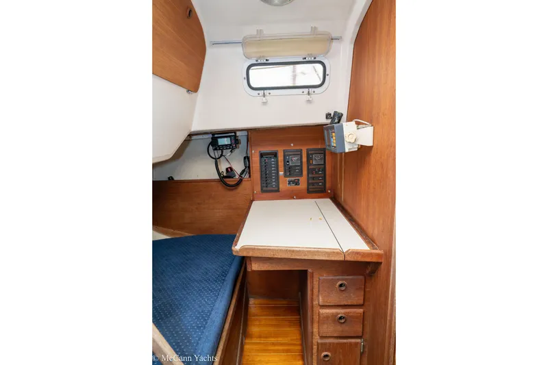 Slide: The Image of 1984 Sabre 32 Aft-Cabin interior with navigation station and wooden cabinetry. - 41